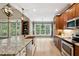 Bright open kitchen with a large island, copper sink, stone countertops, and breakfast area with natural lighting at 3421 Griffice Mill Rd, Raleigh, NC 27610