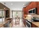 Bright kitchen with wood cabinetry, granite countertops, and stainless steel appliances at 3421 Griffice Mill Rd, Raleigh, NC 27610