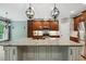Modern kitchen with an island, stainless steel appliances, stone backsplash, and custom cabinetry at 3421 Griffice Mill Rd, Raleigh, NC 27610