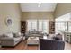 Inviting living room with hardwood floors, large windows, and open access to the dining area at 3421 Griffice Mill Rd, Raleigh, NC 27610