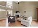 Spacious living room featuring a fireplace, large windows, and a view to the upper level at 3421 Griffice Mill Rd, Raleigh, NC 27610