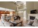 Spacious living room featuring hardwood floors, fireplace, and open access to the kitchen with island and seating at 3421 Griffice Mill Rd, Raleigh, NC 27610