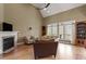 Vaulted living room featuring a fireplace, large windows, and hardwood floors at 3421 Griffice Mill Rd, Raleigh, NC 27610