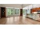 Living room featuring hardwood floors, custom bookshelves, large windows, and open to the modern kitchen at 3421 Griffice Mill Rd, Raleigh, NC 27610