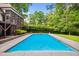 Inviting swimming pool features a stone patio and a verdant, manicured garden at 3421 Griffice Mill Rd, Raleigh, NC 27610