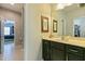 Well-lit bathroom vanity with framed mirror and decorative wall art at 3508 Longleaf Estates Dr, Raleigh, NC 27616