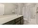 Clean, tiled bathroom with a shower-tub combo and a dark-stained vanity at 3508 Longleaf Estates Dr, Raleigh, NC 27616