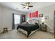 Well-lit bedroom with a ceiling fan, carpet and NC State decor at 3508 Longleaf Estates Dr, Raleigh, NC 27616