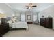 The well-lit bedroom boasts neutral walls, plush carpeting and a ceiling fan at 3508 Longleaf Estates Dr, Raleigh, NC 27616