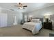 Large bedroom featuring a ceiling fan, natural light, carpet, and ensuite bathroom and walk-in closet at 3508 Longleaf Estates Dr, Raleigh, NC 27616