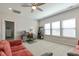 Bright bonus room with a ceiling fan, a desk area with large windows and seating area with a comfortable couch at 3508 Longleaf Estates Dr, Raleigh, NC 27616
