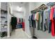 Walk-in closet featuring custom shelving, hanging racks, carpet, and storage space at 3508 Longleaf Estates Dr, Raleigh, NC 27616