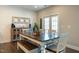 Dining room with long table, bench seating, and access to backyard via double doors at 3508 Longleaf Estates Dr, Raleigh, NC 27616