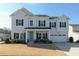 Charming two-story home with a well-manicured lawn, a two-car garage, and a welcoming front porch at 3508 Longleaf Estates Dr, Raleigh, NC 27616
