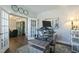 Well-lit home office with an adjustable standing desk and views into the living space at 3508 Longleaf Estates Dr, Raleigh, NC 27616