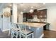 Bright eat-in kitchen features granite countertops, stainless appliances, dark cabinetry, and pendant lighting at 3508 Longleaf Estates Dr, Raleigh, NC 27616