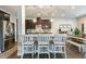 Bright eat-in kitchen features granite countertops, stainless appliances, dark cabinetry, and pendant lighting at 3508 Longleaf Estates Dr, Raleigh, NC 27616