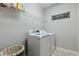Functional laundry room with a modern washer and dryer set and wire shelving at 3508 Longleaf Estates Dr, Raleigh, NC 27616
