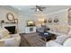 Living room featuring a fireplace, plush seating, TV, ceiling fan, and natural light at 3508 Longleaf Estates Dr, Raleigh, NC 27616