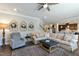 Open concept living room showcasing a large sectional, ceiling fan, and view of the kitchen at 3508 Longleaf Estates Dr, Raleigh, NC 27616