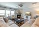 Bright living room boasts plush seating, fireplace, ceiling fan, and large windows for natural light at 3508 Longleaf Estates Dr, Raleigh, NC 27616