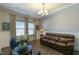 Cozy living room with hardwood floors, large windows, and comfortable seating at 3508 Longleaf Estates Dr, Raleigh, NC 27616