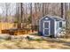 A well-maintained shed adjacent to the garden area, offering storage for gardening tools and outdoor equipment at 409 Tintern Ln, Apex, NC 27523