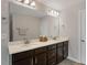 Bathroom with double vanity, modern hardware, and a large mirror at 421 Pine Burr St, Fuquay Varina, NC 27526