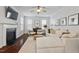 Bright living room with a fireplace, neutral color palette, hardwood floors and comfortable seating at 421 Pine Burr St, Fuquay Varina, NC 27526