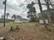 Large backyard featuring a small storage building and mature trees providing shade at 4989 Nc 217, Erwin, NC 28339