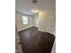 Bedroom with dark wood-look flooring, light walls, window, and white trim at 4989 Nc 217, Erwin, NC 28339