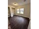 This bedroom features dual windows, built in shelving and dark wood-look flooring at 4989 Nc 217, Erwin, NC 28339