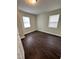Cozy bedroom featuring dual windows for natural light and dark wood-look flooring at 4989 Nc 217, Erwin, NC 28339