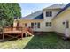 Rear exterior view featuring a deck, patio, and lush greenery at 509 Edgemore Ave, Cary, NC 27519