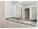 Bathroom vanity featuring granite countertops and double sinks with large mirror at 509 Edgemore Ave, Cary, NC 27519