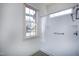 Bathroom showcasing a white tiled shower and a window overlooking verdant exterior at 509 Edgemore Ave, Cary, NC 27519