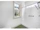Bathroom showcasing a white tiled shower and a window allowing ample natural light at 509 Edgemore Ave, Cary, NC 27519