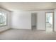 Spacious carpeted bedroom with windows, ceiling fan, and an ensuite bathroom at 509 Edgemore Ave, Cary, NC 27519