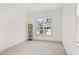 Bright bedroom with plush carpet, a ceiling fan, and a large window overlooking a leafy street at 509 Edgemore Ave, Cary, NC 27519