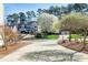 Home exterior featuring a manicured front yard and long driveway at 509 Edgemore Ave, Cary, NC 27519
