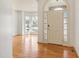 Light-filled foyer with hardwood flooring, a decorative front door, and a view of the front yard at 509 Edgemore Ave, Cary, NC 27519