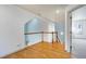 Hallway with hardwood floors and traditional wood and white banister leading to stairs at 509 Edgemore Ave, Cary, NC 27519