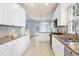 Charming kitchen with white cabinets, granite countertops, stainless steel appliances, and open floor plan at 509 Edgemore Ave, Cary, NC 27519