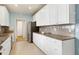 Bright kitchen with white cabinets, stainless steel appliances, granite countertops, and tile backsplash at 509 Edgemore Ave, Cary, NC 27519