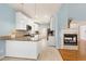 Open-concept kitchen with white cabinets, granite countertops, stainless steel appliances, and tile flooring at 509 Edgemore Ave, Cary, NC 27519