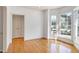 Bright living area featuring hardwood floors, a bay window, and ample natural light at 509 Edgemore Ave, Cary, NC 27519