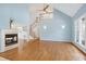 Spacious living room featuring hardwood floors, a fireplace, stairs to second floor, and large windows at 509 Edgemore Ave, Cary, NC 27519