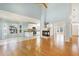 Open-concept living area with fireplace, hardwood floors, and an eat-in kitchen featuring stainless steel appliances at 509 Edgemore Ave, Cary, NC 27519