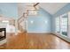 Spacious living room featuring hardwood floors, a fireplace, stairs to second floor, and large windows at 509 Edgemore Ave, Cary, NC 27519