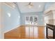 Open living room with a vaulted ceiling, a fireplace, and ample natural light from large windows at 509 Edgemore Ave, Cary, NC 27519